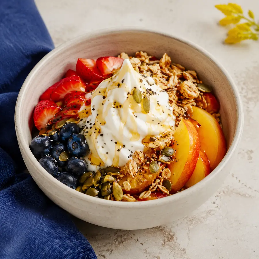 Loaded Greek yogurt bowl with seasonal fruit and granola